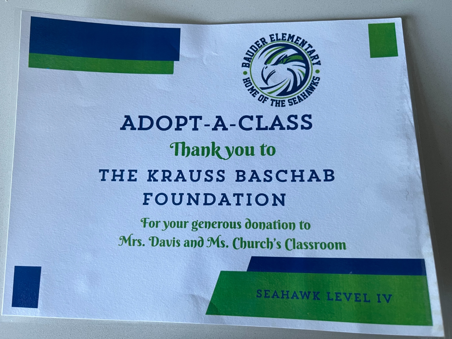 A blue and green thank-you card from Bauder Elementary reading 'Adopt-A-Class — Thank you to The Krauss Baschab Foundation — Seahawk Level IV.'